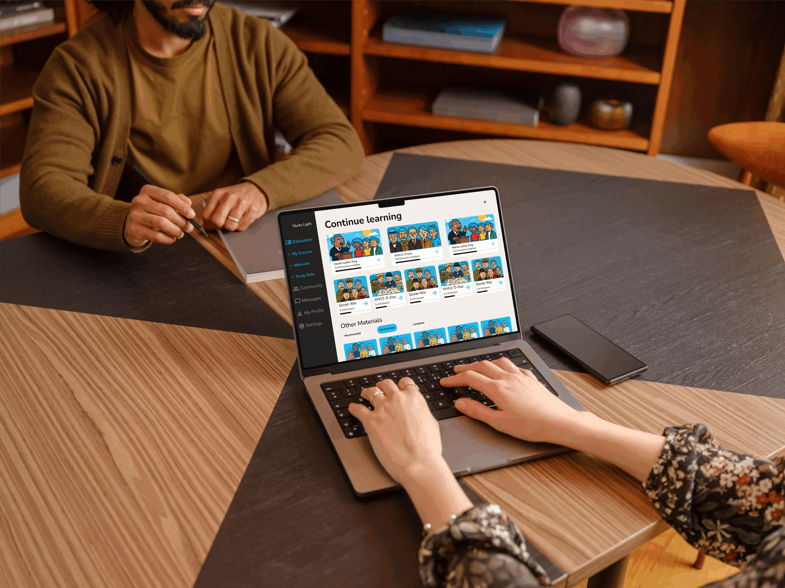 Female typing on a MacBook Pro mockup in the office (Mockuuups Studio)